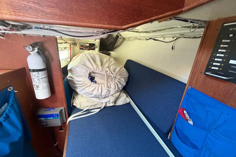 Slide: The Image of Interior of 1984 C&C 33 MK II sailboat with blue seating and safety equipment. - 42