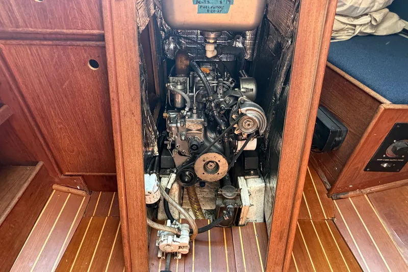 Slide: The Image of Engine compartment of a 1984 C&C 33 MK II sailboat, showcasing detailed mechanical components. - 62