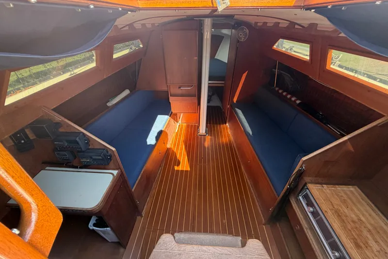 Slide: The Image of Interior of 1984 C&C 33 MK II sailboat with wooden finish and blue seating. - 31