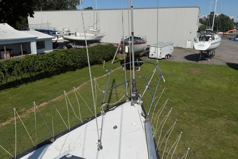 Slide: The Image of Bow view of a 1984 C&C 33 MK II sailboat in a boatyard setting. - 21