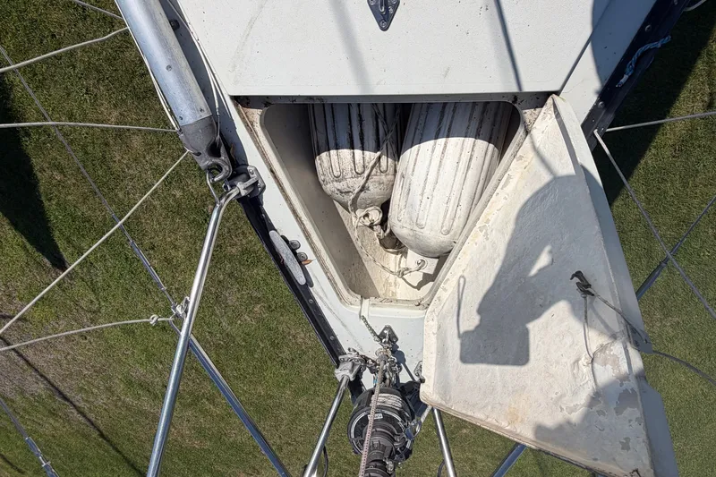 Slide: The Image of Open hatch on 1984 C&C 33 MK II sailboat, revealing stored fenders. - 23