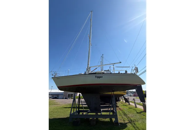 Slide: The Image of 1984 C&C 33 MK II sailboat on stands under clear blue sky. - 1