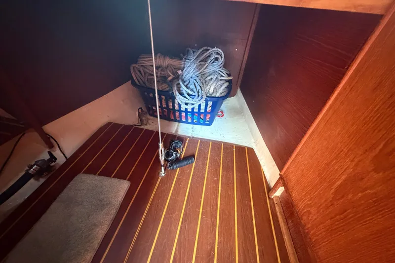 Slide: The Image of Interior of 1984 C&C 33 MK II sailboat with rope basket and wooden flooring. - 57