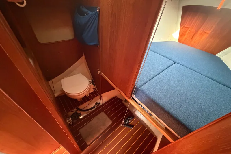 Slide: The Image of 1984 C&C 33 MK II yacht interior with compact bathroom and cozy sleeping area. - 51