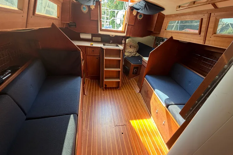 Slide: The Image of Interior of 1984 C&C 33 MK II sailboat with wooden finish and blue seating. - 59
