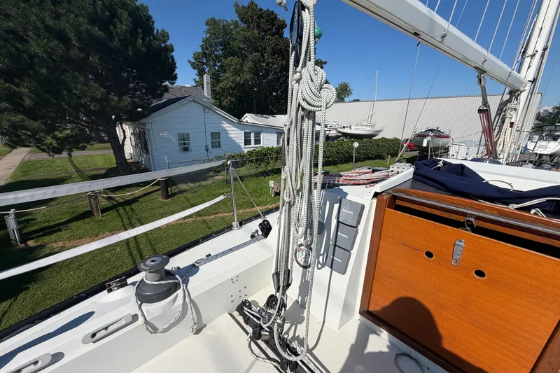 Slide: The Image of 1984 C&C 33 MK II sailboat deck with rigging and wooden hatch. - 12
