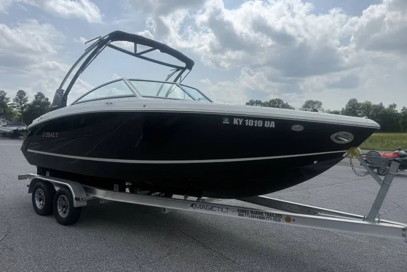 Slide: The Image of 2017 Cobalt R3 boat on trailer under cloudy sky. - 36