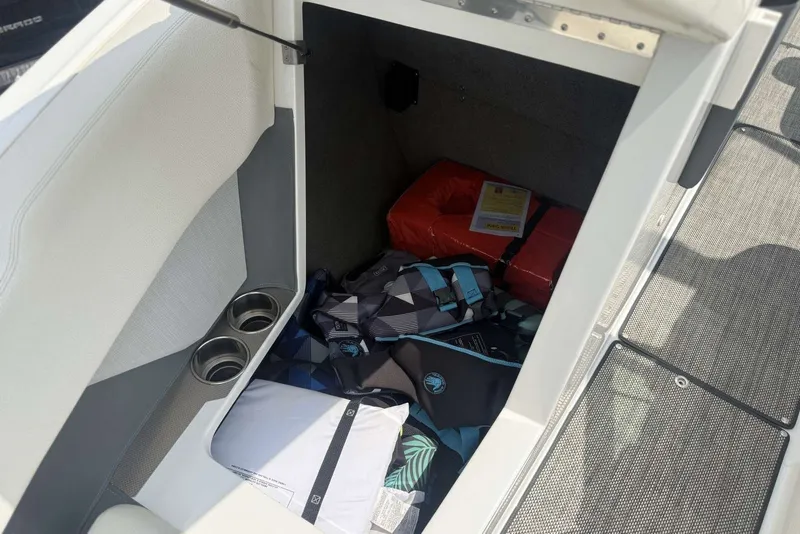 Slide: The Image of Storage compartment in a 2017 Cobalt R3 boat with life jackets and safety gear. - 11