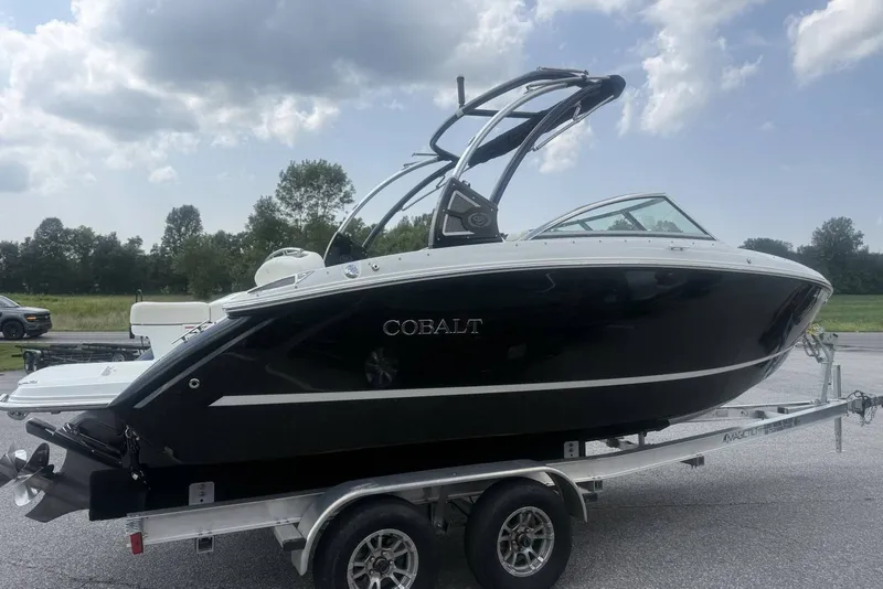 Slide: The Image of 2017 Cobalt R3 boat on trailer, black exterior, parked outdoors under cloudy sky. - 37