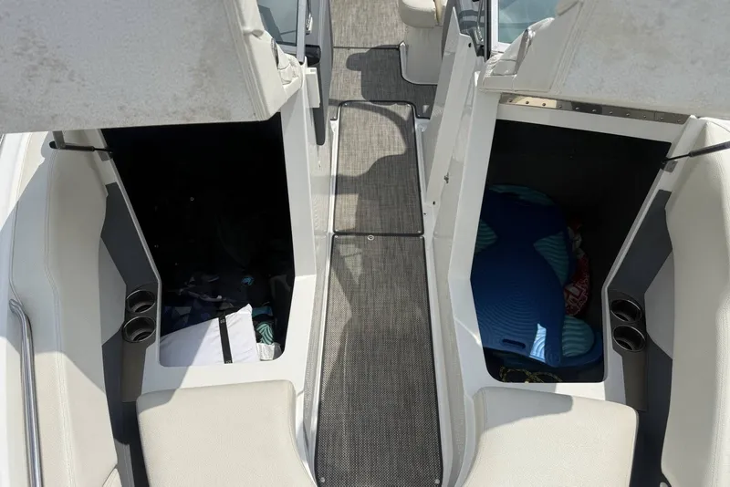 Slide: The Image of Interior view of a 2017 Cobalt R3 boat, featuring storage compartments and seating. - 13