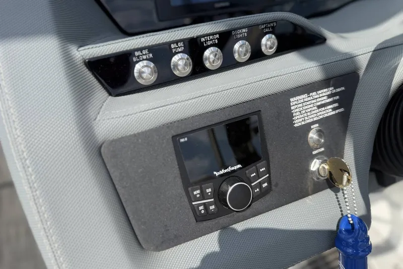 Slide: The Image of Control panel of a 2017 Cobalt R3 boat with audio system and switches. - 17