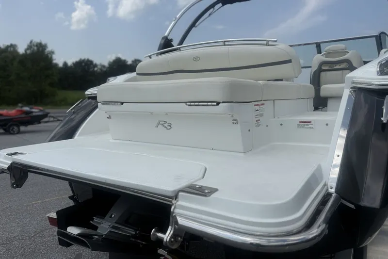 Slide: The Image of 2017 Cobalt R3 boat with white seating and sleek design, parked outdoors. - 6