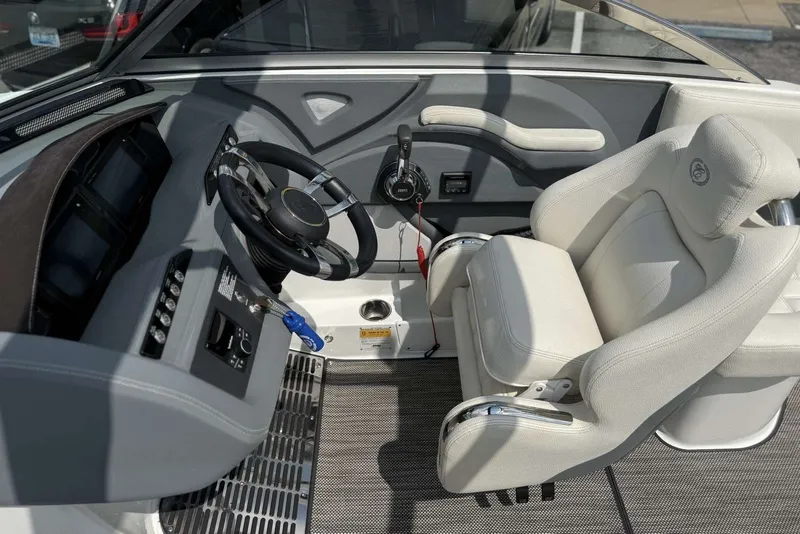 Slide: The Image of 2017 Cobalt R3 boat cockpit with steering wheel and white captain's chair. - 15