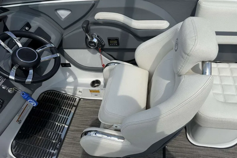 Slide: The Image of Interior of a 2017 Cobalt R3 boat featuring steering wheel and captain's chair. - 24