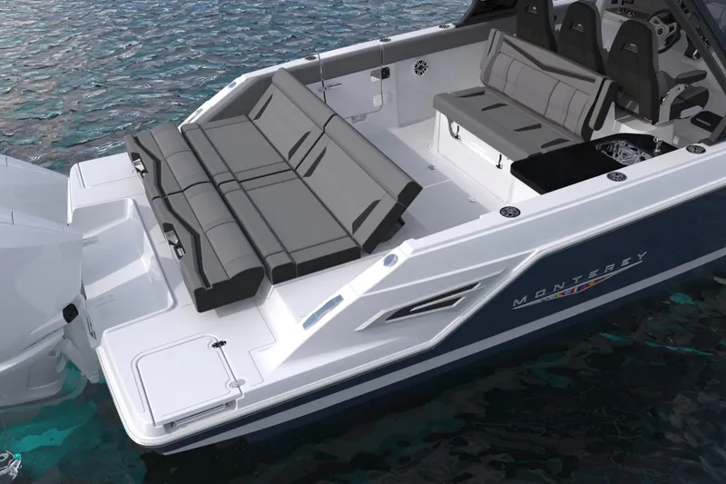Slide: The Image of 2027 Monterey Elite 34 OB boat with sleek seating on calm water. - 9