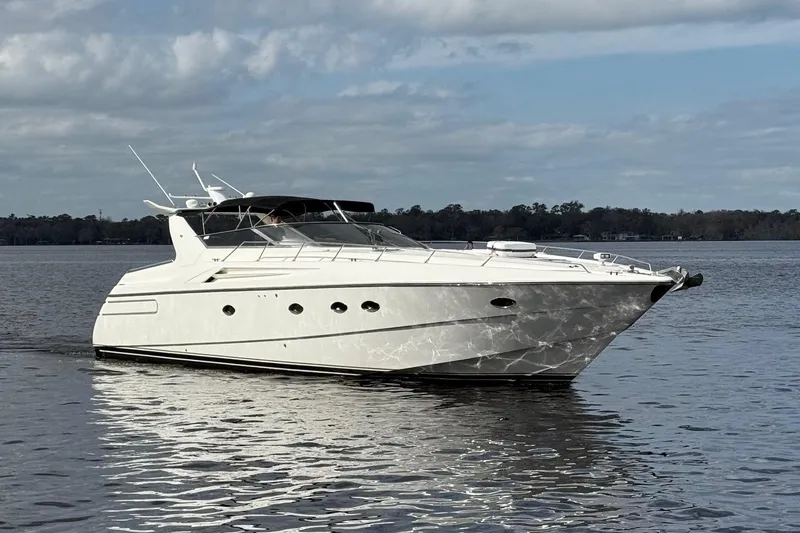 The Image of 1994 Sunseeker Camargue 55 yacht cruising on calm waters under a cloudy sky. - 0