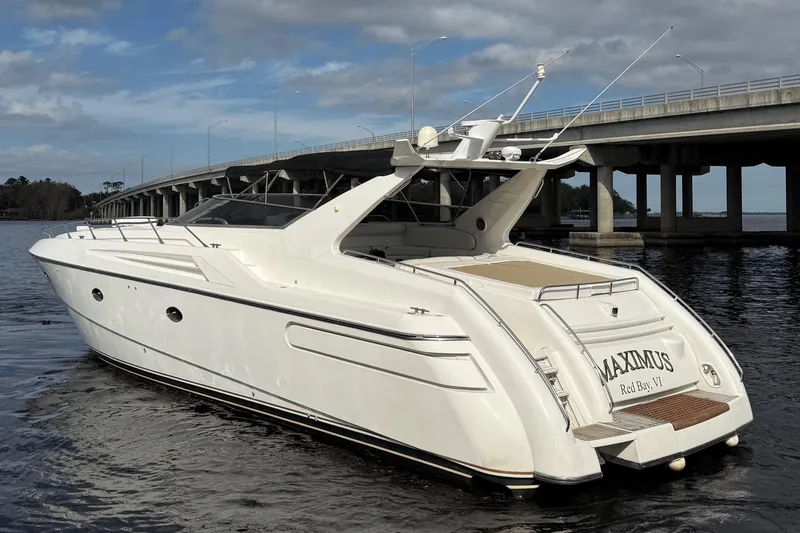 Slide: The Image of 1994 Sunseeker Camargue 55 yacht on water near a bridge, rear view. - 22