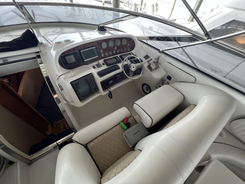 Slide: The Image of 1994 Sunseeker Camargue 55 yacht cockpit with luxurious white seating and advanced control panel. - 5