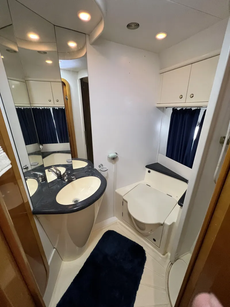 Slide: The Image of Luxurious bathroom in a 1994 Sunseeker Camargue 55 yacht, featuring modern fixtures and ample storage. - 9