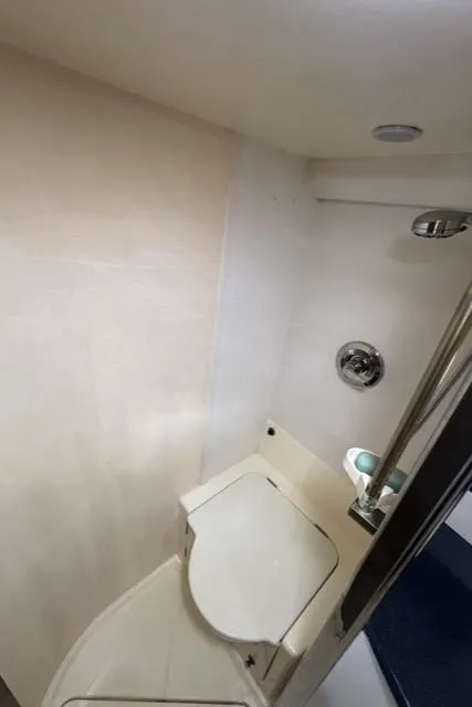 Slide: The Image of Bathroom interior of 1994 Sunseeker Camargue 55 yacht, featuring compact design and modern fixtures. - 13
