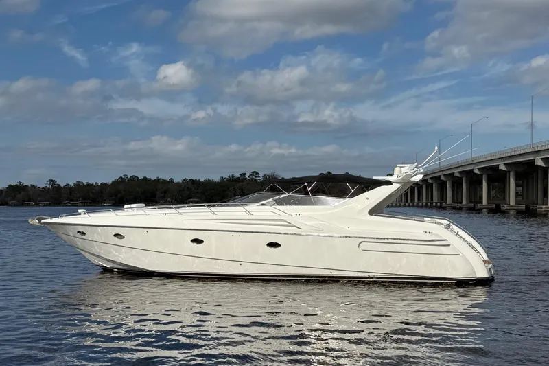 Slide: The Image of 1994 Sunseeker Camargue 55 yacht on calm water near a bridge. - 1