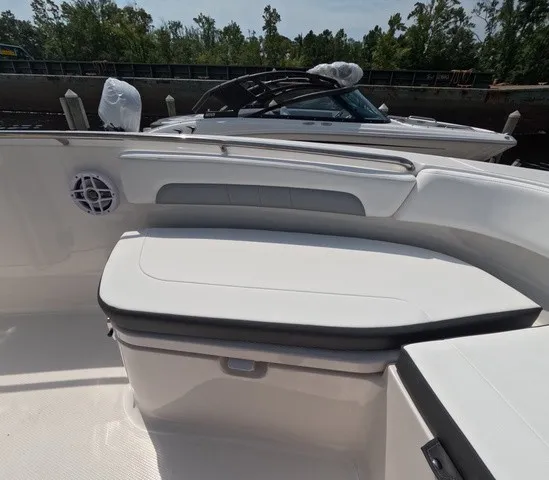 Slide: The Image of The image shows the cockpit of a 2027 Robalo Explorer R202EX with white upholstery. - 19