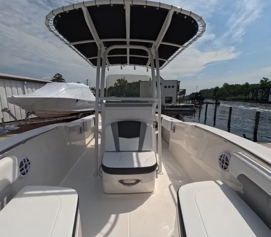Slide: The Image of The image shows a 2027 Robalo Explorer R202EX boat with a shaded T-top. - 25