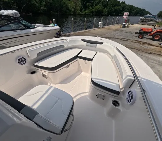 Slide: The Image of The image shows the bow area of a Robalo Explorer R202EX boat with white seating and speakers. - 16