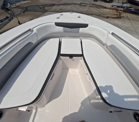 Slide: The Image of The image shows the bow area of a 2027 Robalo Explorer R202EX with white cushioned seating. - 18