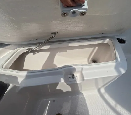 Slide: The Image of An open storage compartment on a 2027 Robalo Explorer R202EX boat. - 22