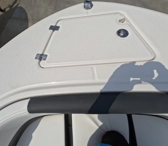 Slide: The Image of The image shows the bow deck of a Robalo Explorer R202EX boat with an access hatch. - 23