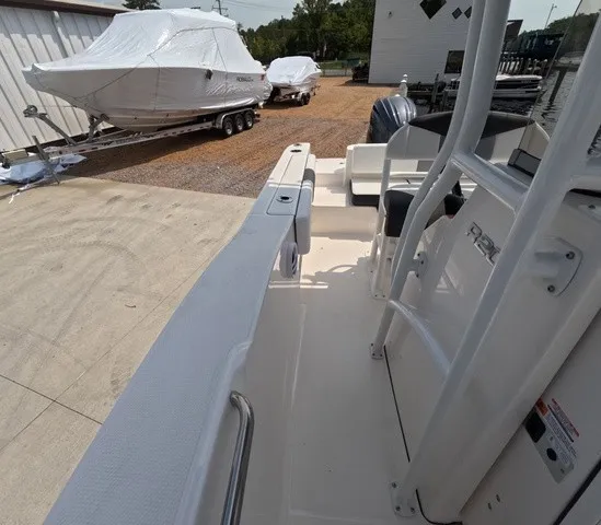 Slide: The Image of The image shows the deck of a Robalo Explorer R202EX boat. Other boats are visible in the background. - 29
