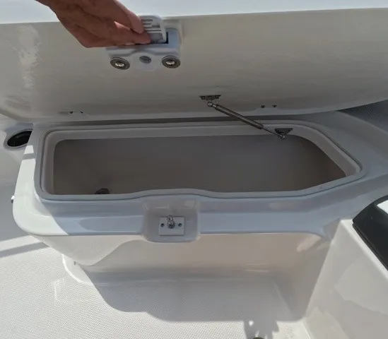 Slide: The Image of An open storage compartment on a 2027 Robalo Explorer R202EX boat. - 20