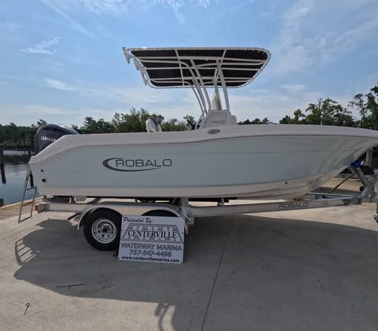 The Image of A 2027 Robalo Explorer R202EX on a trailer on a sunny day. - 1