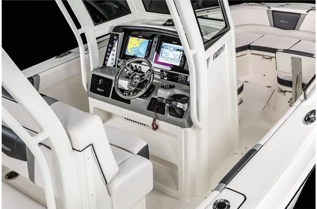 Slide: The Image of The image shows the cockpit of a 2021 Robalo R272 Center Console boat with modern electronics. - 21
