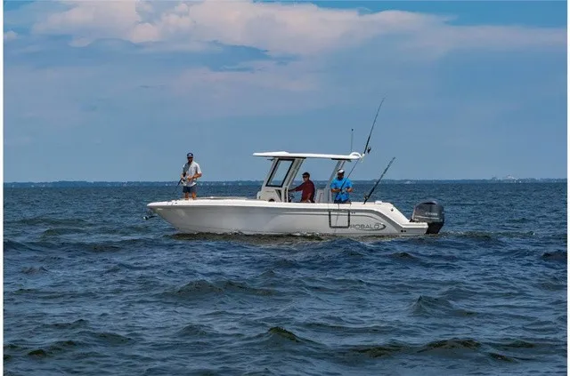 Slide: The Image of Three people are fishing on a white Robalo R272 Center Console boat in the sea. - 15
