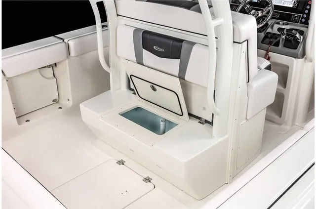 Slide: The Image of The image shows the cockpit of a 2021 Robalo R272 Center Console boat with seating and storage. - 24