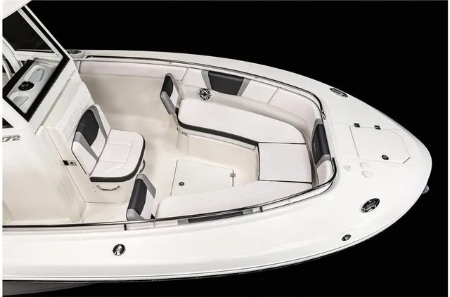 Slide: The Image of The image shows the bow of a 2021 Robalo R272 Center Console boat with white upholstery. - 17
