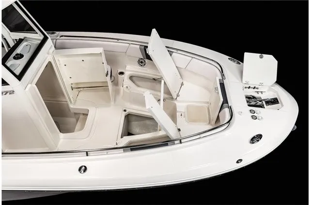 Slide: The Image of The image shows the deck of a Robalo R272 Center Console boat with several open storage compartments. - 19
