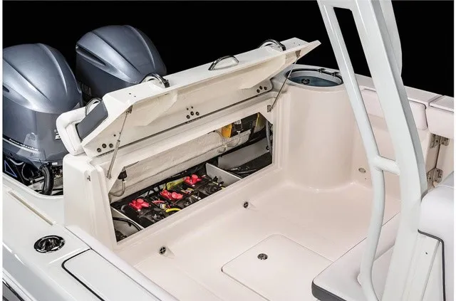 Slide: The Image of The image shows the rear area of a 2021 Robalo R272 Center Console boat with open storage. - 27
