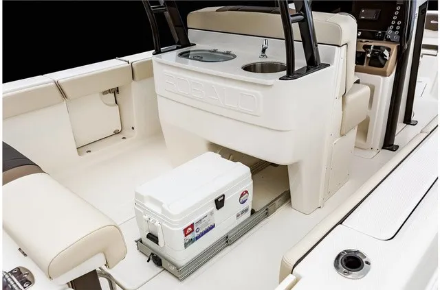 Slide: The Image of The image shows the cockpit of a 2021 Robalo R272 Center Console boat with seating and a cooler. - 25