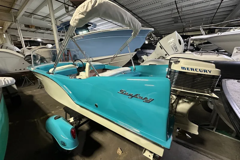 Slide: The Image of 1959 Seafury 14' Antique boat with Mercury engine in a showroom. - 3