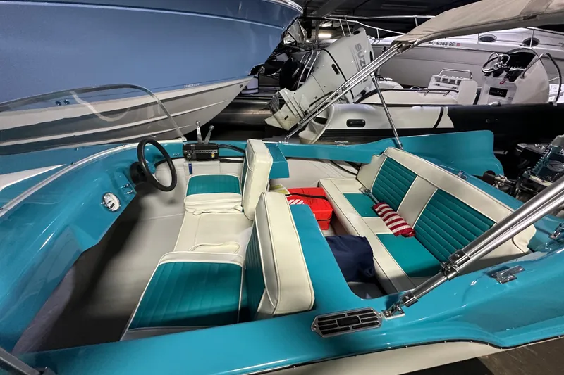 Slide: The Image of 1959 Seafury 14' Antique boat with teal and white interior, docked indoors. - 6