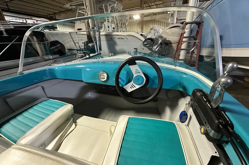 Slide: The Image of Interior of a 1959 Seafury 14' Antique boat with turquoise and white seating. - 8