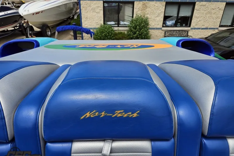 Slide: The Image of 2010 Nor-Tech 4300V boat interior with blue and silver seating, logo visible. - 98