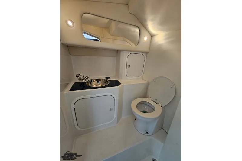 Slide: The Image of 2010 Nor-Tech 4300V boat bathroom with sink, toilet, and mirror. - 91