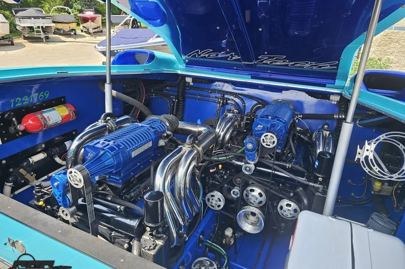 Slide: The Image of Engine compartment of a 2010 Nor-Tech 4300V boat, showcasing powerful machinery and components. - 105