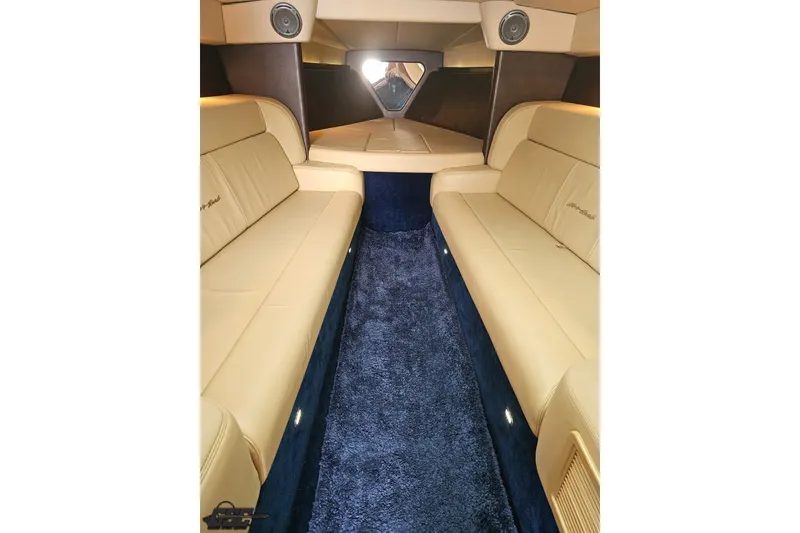 Slide: The Image of Luxurious interior of 2010 Nor-Tech 4300V boat with beige seating and blue carpet. - 81