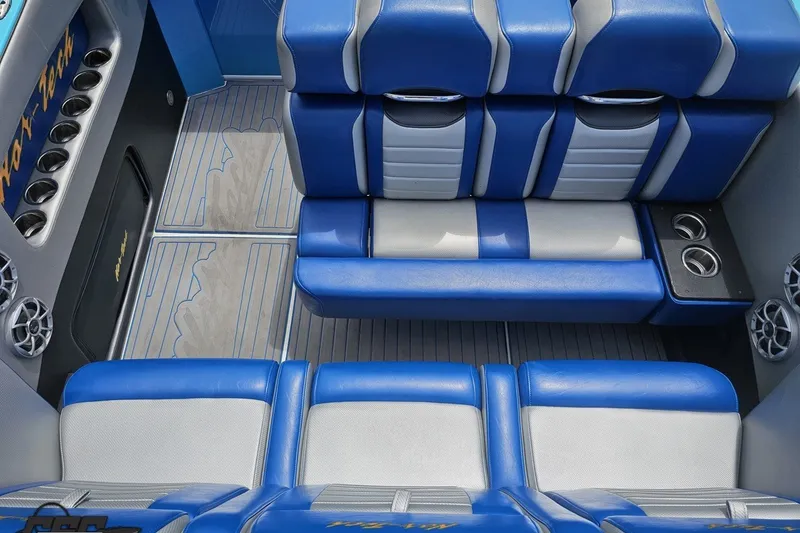 Slide: The Image of Interior of 2010 Nor-Tech 4300V boat with blue and gray seating and cup holders. - 61