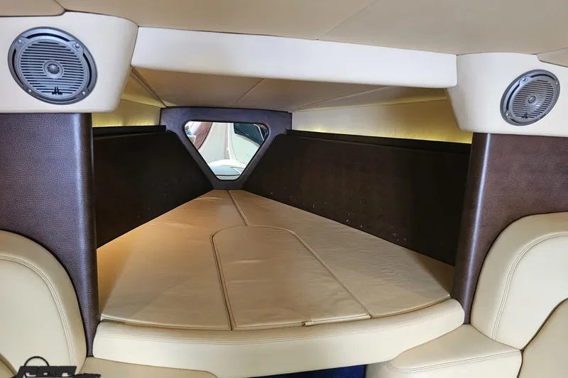 Slide: The Image of Interior cabin of a 2010 Nor-Tech 4300V boat with beige and brown upholstery. - 87